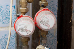 two water meters on pipes in a home